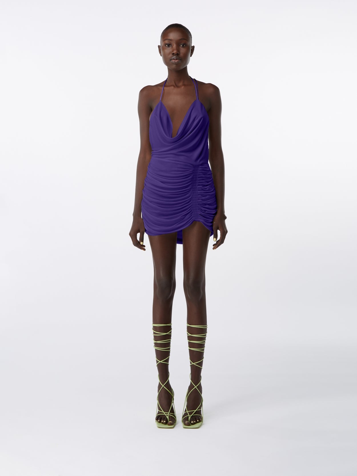 model wearing purple halter neck mini dress with open back
