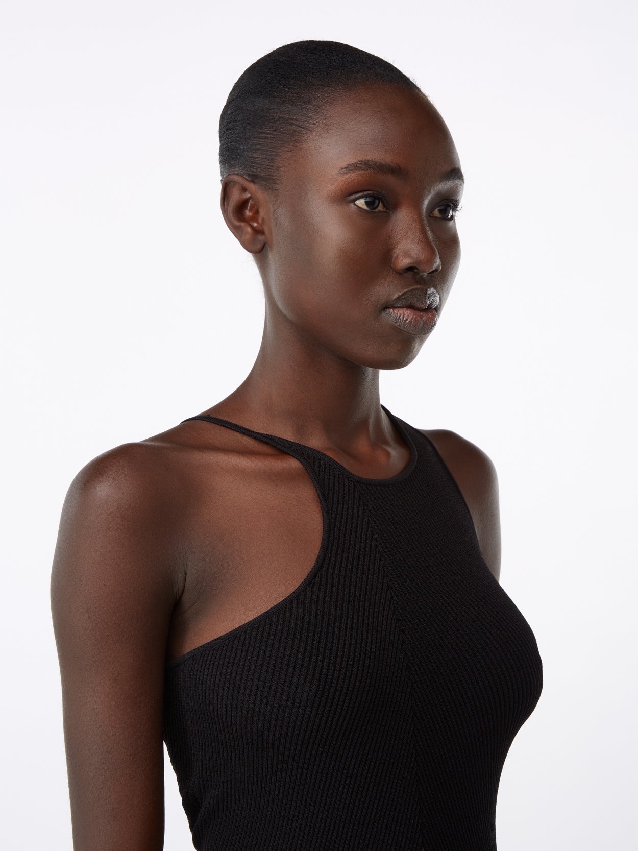 clsoe up of a model wearing a black knit jumpsuit