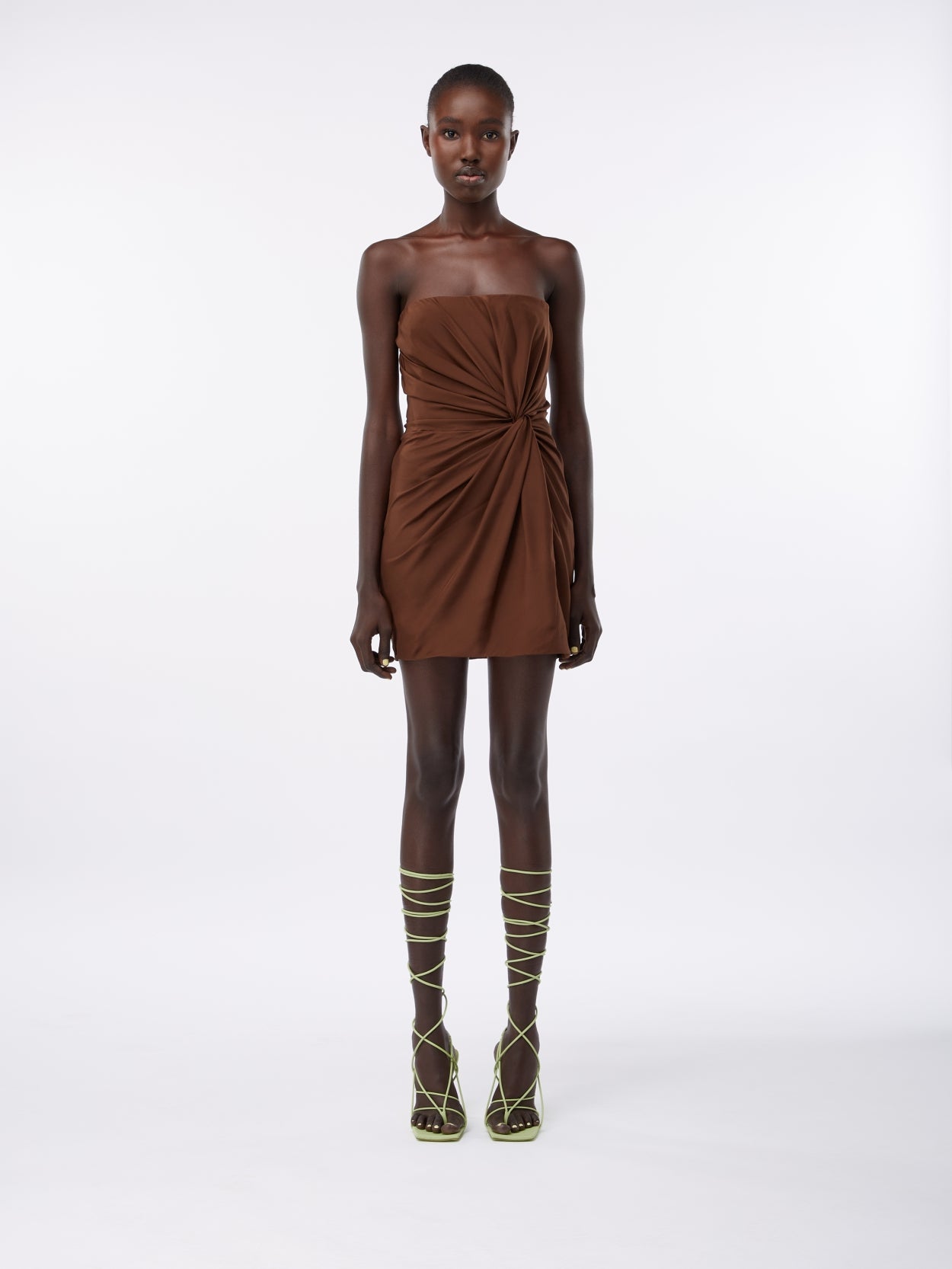 model wearing a brown mini silk dress with knot detail